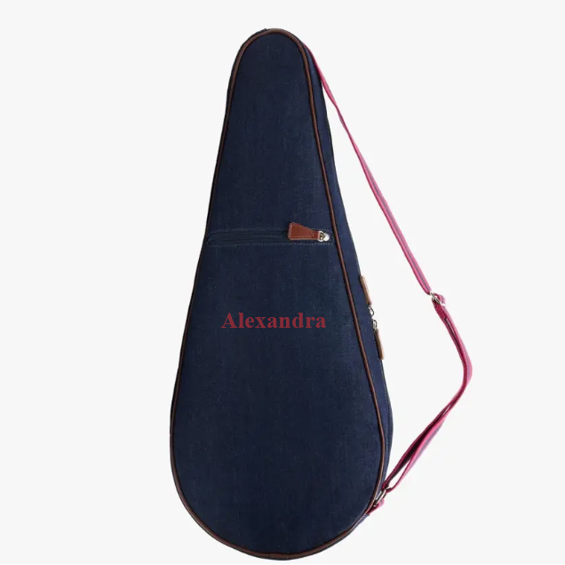 A dark navy blue guitar or ukulele case with a pink strap and a pink personalized name 'Alexandra' printed on the front, shown against a plain white background.
